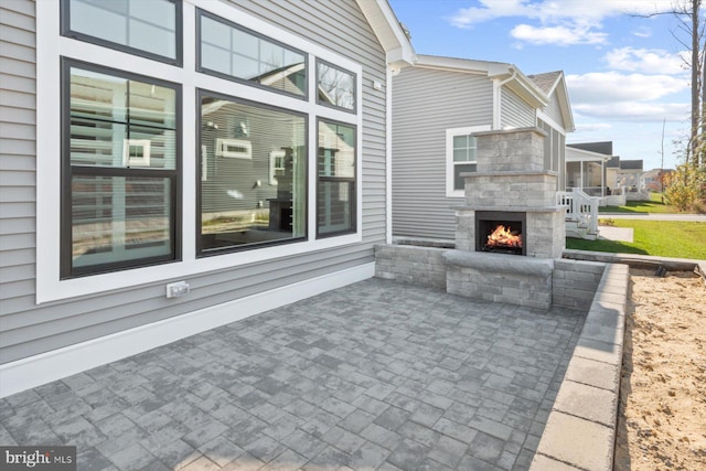 view of patio featuring exterior fireplace