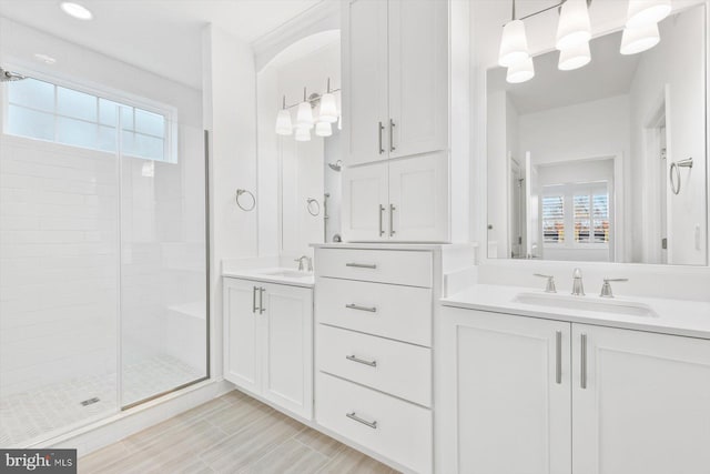 bathroom with vanity, plenty of natural light, and a shower with shower door