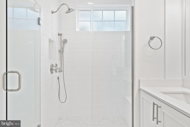 bathroom with a shower with door and vanity