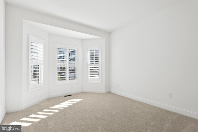 empty room featuring light carpet