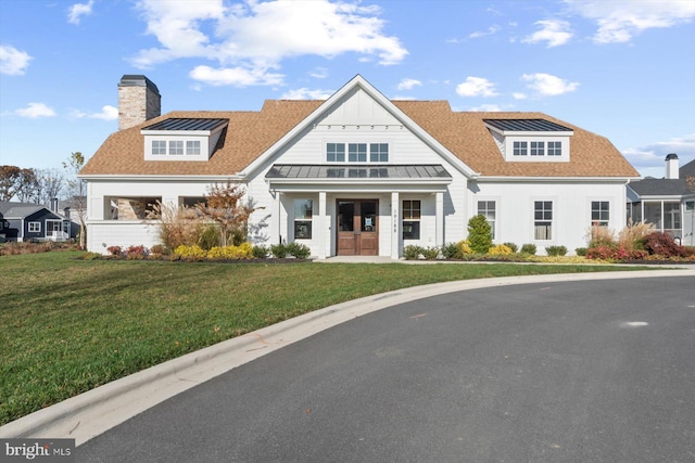 view of front of property featuring a front yard and french doors