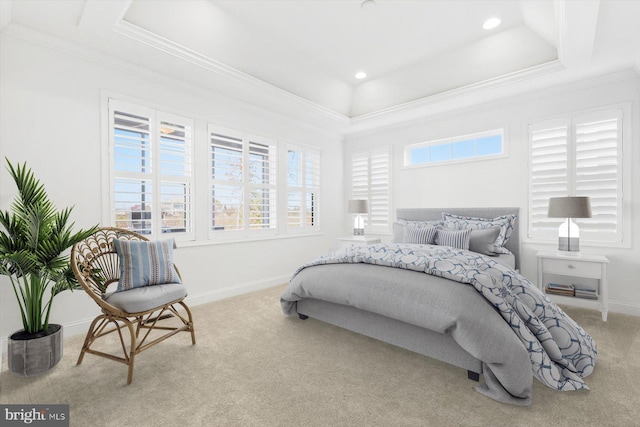 bedroom featuring a tray ceiling, crown molding, and light colored carpet