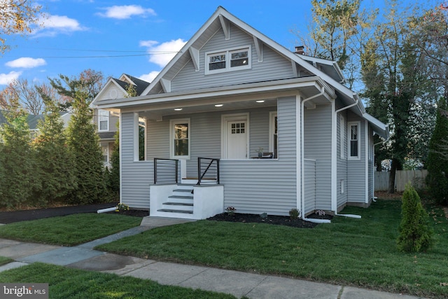 bungalow-style home with a front yard