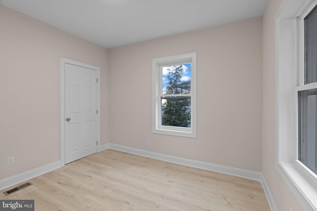 spare room featuring light wood-type flooring