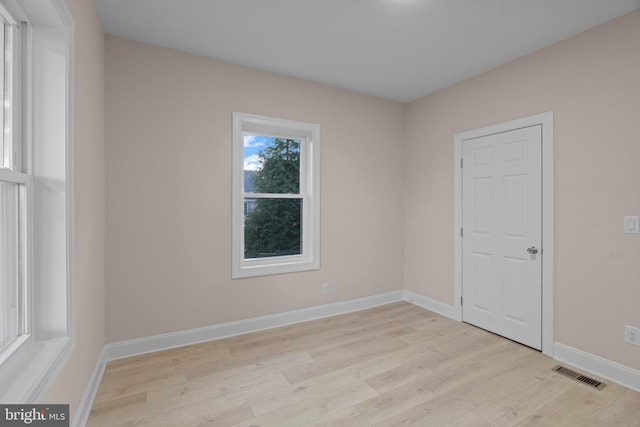 empty room with light hardwood / wood-style flooring