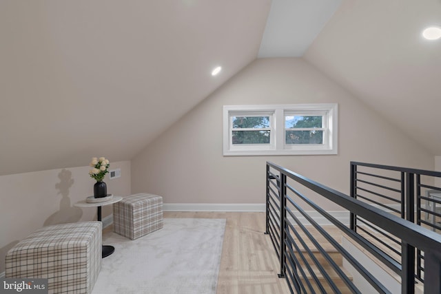 living area featuring light hardwood / wood-style flooring and lofted ceiling