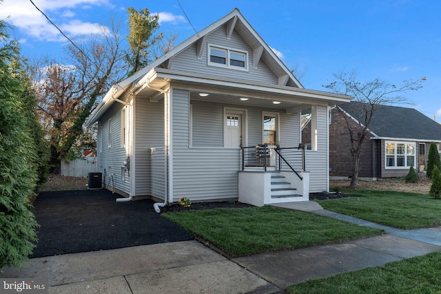 bungalow-style home with a front lawn