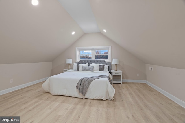 bedroom with lofted ceiling and light wood-type flooring