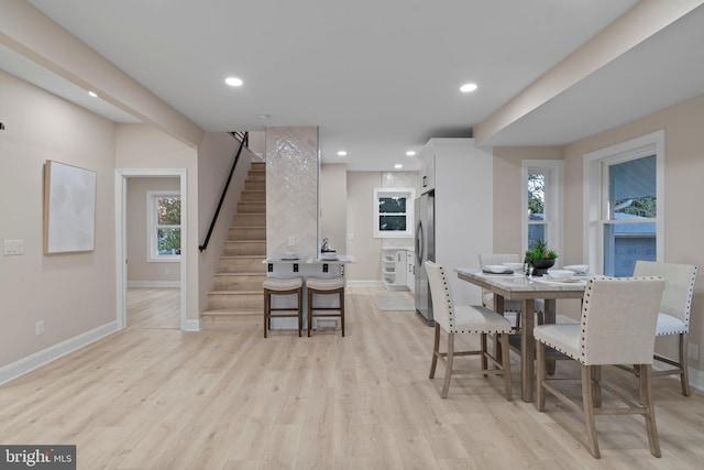 dining area featuring a healthy amount of sunlight and light hardwood / wood-style floors