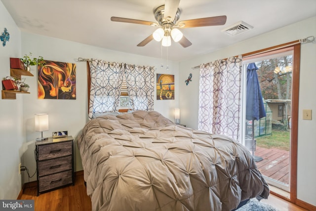 bedroom with access to exterior, multiple windows, and ceiling fan