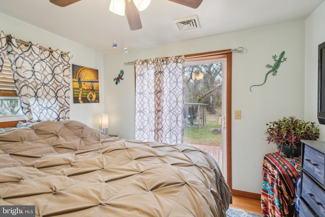 bedroom featuring multiple windows, ceiling fan, and light hardwood / wood-style flooring