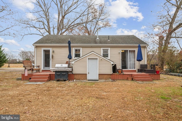 back of property with a yard and a deck