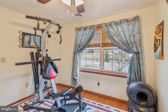 exercise room featuring ceiling fan and light hardwood / wood-style flooring