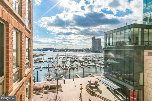 balcony with a boat dock and a water view