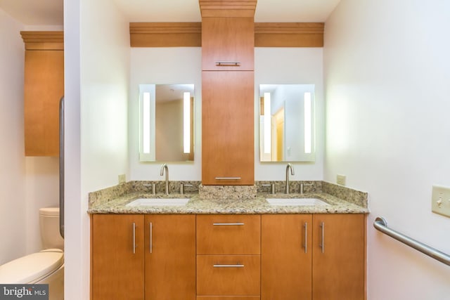 bathroom with vanity, toilet, and crown molding