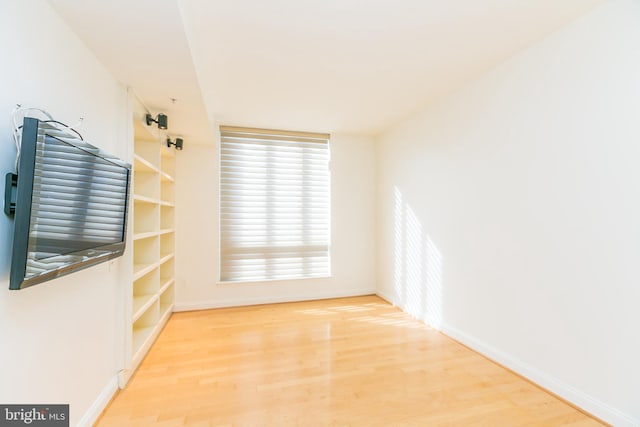 spare room featuring wood-type flooring