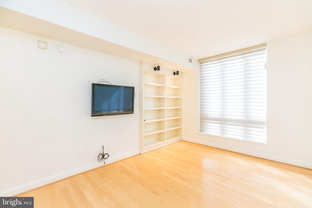 unfurnished living room featuring wood-type flooring