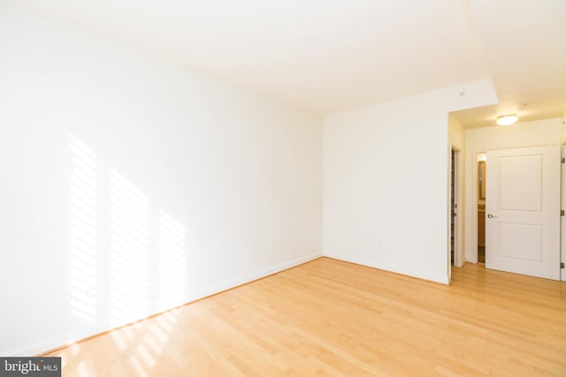 unfurnished room with wood-type flooring