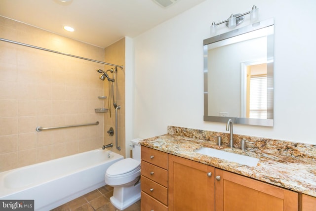 full bathroom with tile patterned flooring, toilet, vanity, and tiled shower / bath