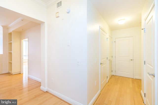 corridor featuring light hardwood / wood-style floors and ornamental molding