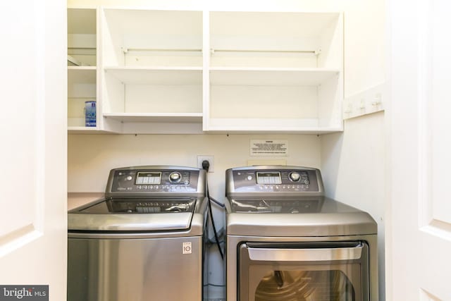 washroom with washing machine and clothes dryer