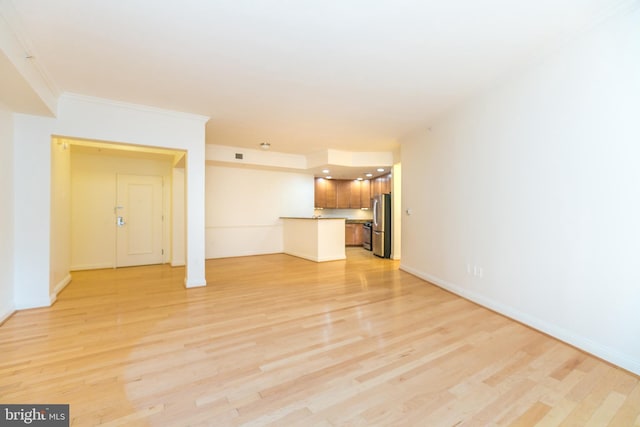 unfurnished living room featuring light wood-type flooring and ornamental molding