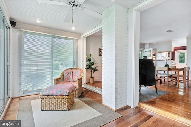 living area featuring ceiling fan, wood finished floors, visible vents, and recessed lighting