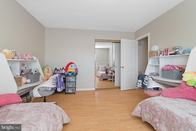 bedroom with wood-type flooring and a closet