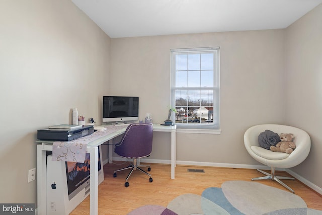 office area with light hardwood / wood-style floors