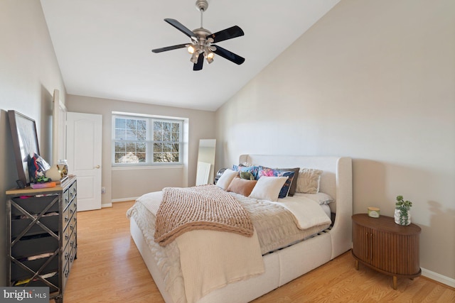 bedroom with lofted ceiling, light hardwood / wood-style flooring, and ceiling fan