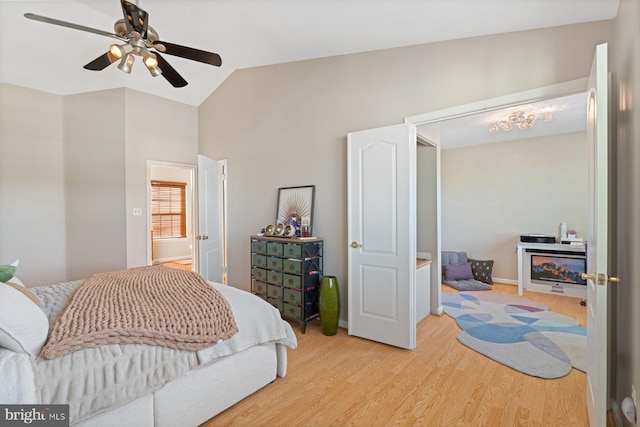 bedroom featuring vaulted ceiling, ceiling fan, and light wood-type flooring