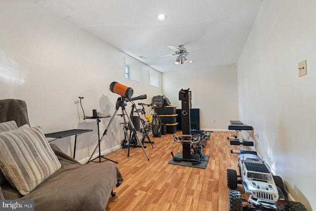 workout room featuring wood-type flooring and ceiling fan