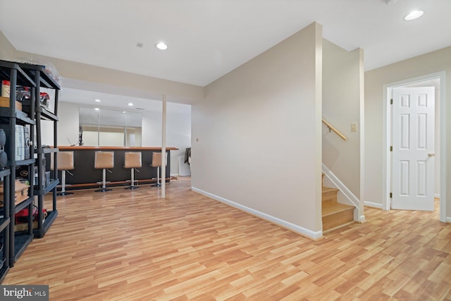 office area featuring bar and light hardwood / wood-style flooring