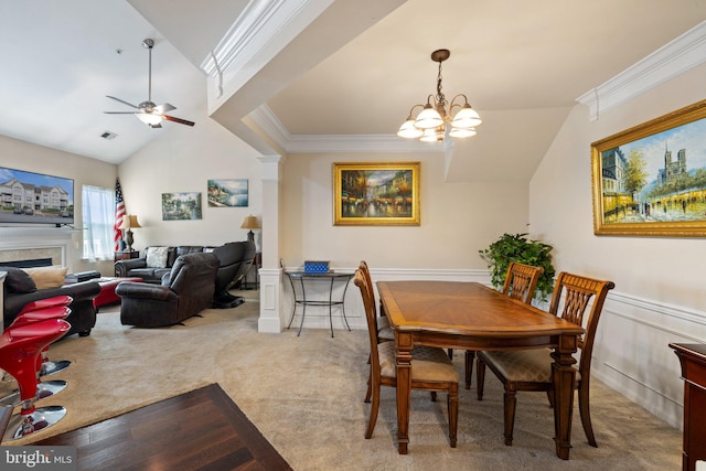 dining area featuring vaulted ceiling, a fireplace, carpet floors, and ornamental molding