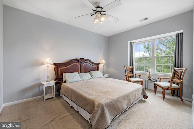 bedroom featuring visible vents, baseboards, light colored carpet, and ceiling fan