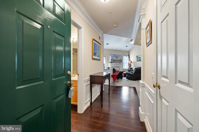 entryway featuring ceiling fan, dark wood-type flooring, lofted ceiling, and ornamental molding