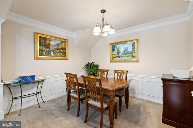 dining area featuring light carpet, a chandelier, wainscoting, and crown molding