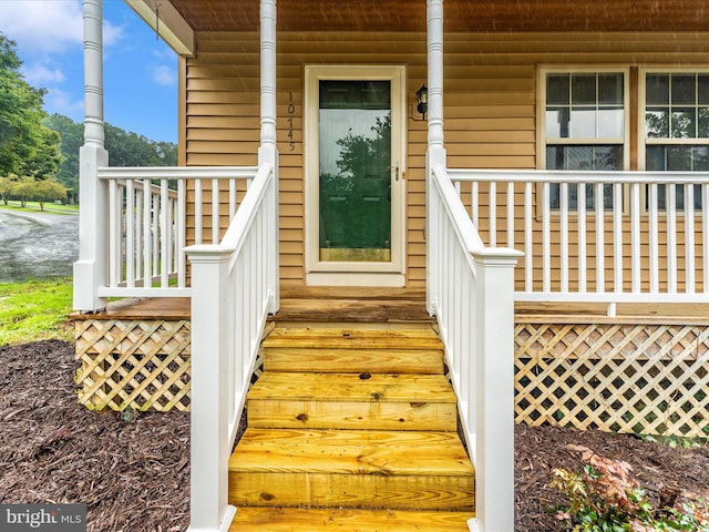 view of exterior entry featuring a porch