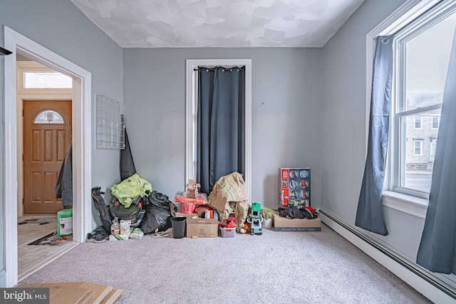 game room with carpet floors and a baseboard heating unit