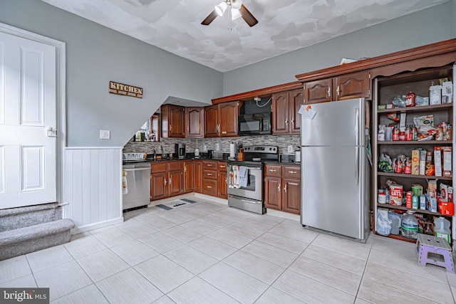 kitchen with ceiling fan, light tile patterned floors, appliances with stainless steel finishes, and tasteful backsplash