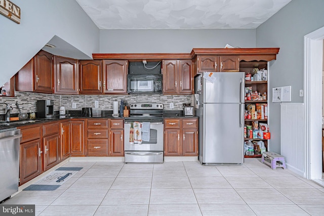 kitchen featuring tasteful backsplash, light tile patterned flooring, and stainless steel appliances