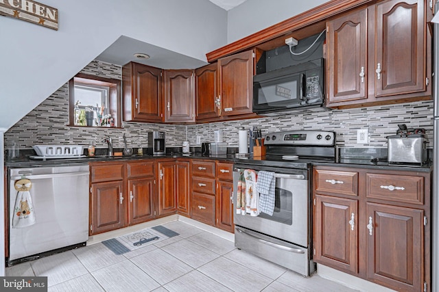 kitchen with decorative backsplash, appliances with stainless steel finishes, light tile patterned floors, and sink