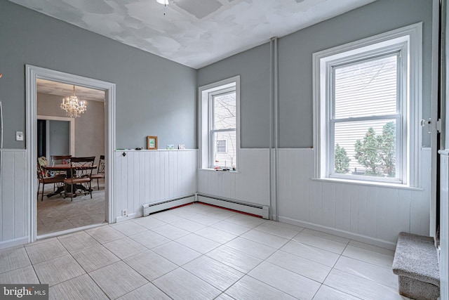 interior space with a chandelier and a baseboard radiator