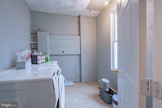 laundry room featuring washer and dryer and light tile patterned floors