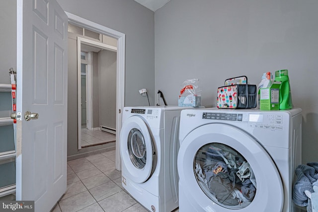 laundry area with independent washer and dryer, a baseboard radiator, and light tile patterned floors