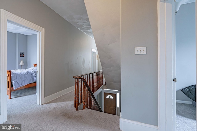 stairs featuring carpet and vaulted ceiling