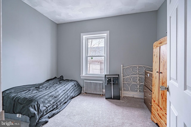 bedroom with carpet flooring and radiator heating unit