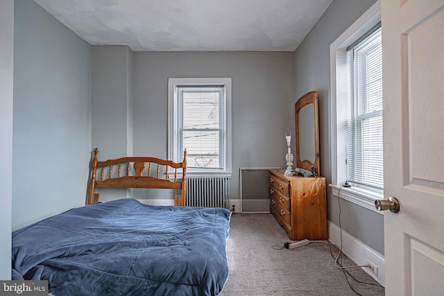 carpeted bedroom with radiator