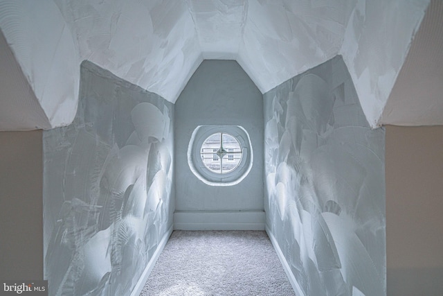 interior space featuring carpet flooring and lofted ceiling