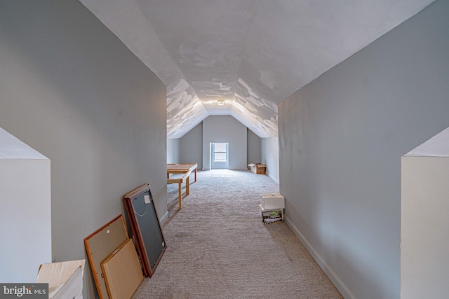 bonus room featuring light carpet and vaulted ceiling